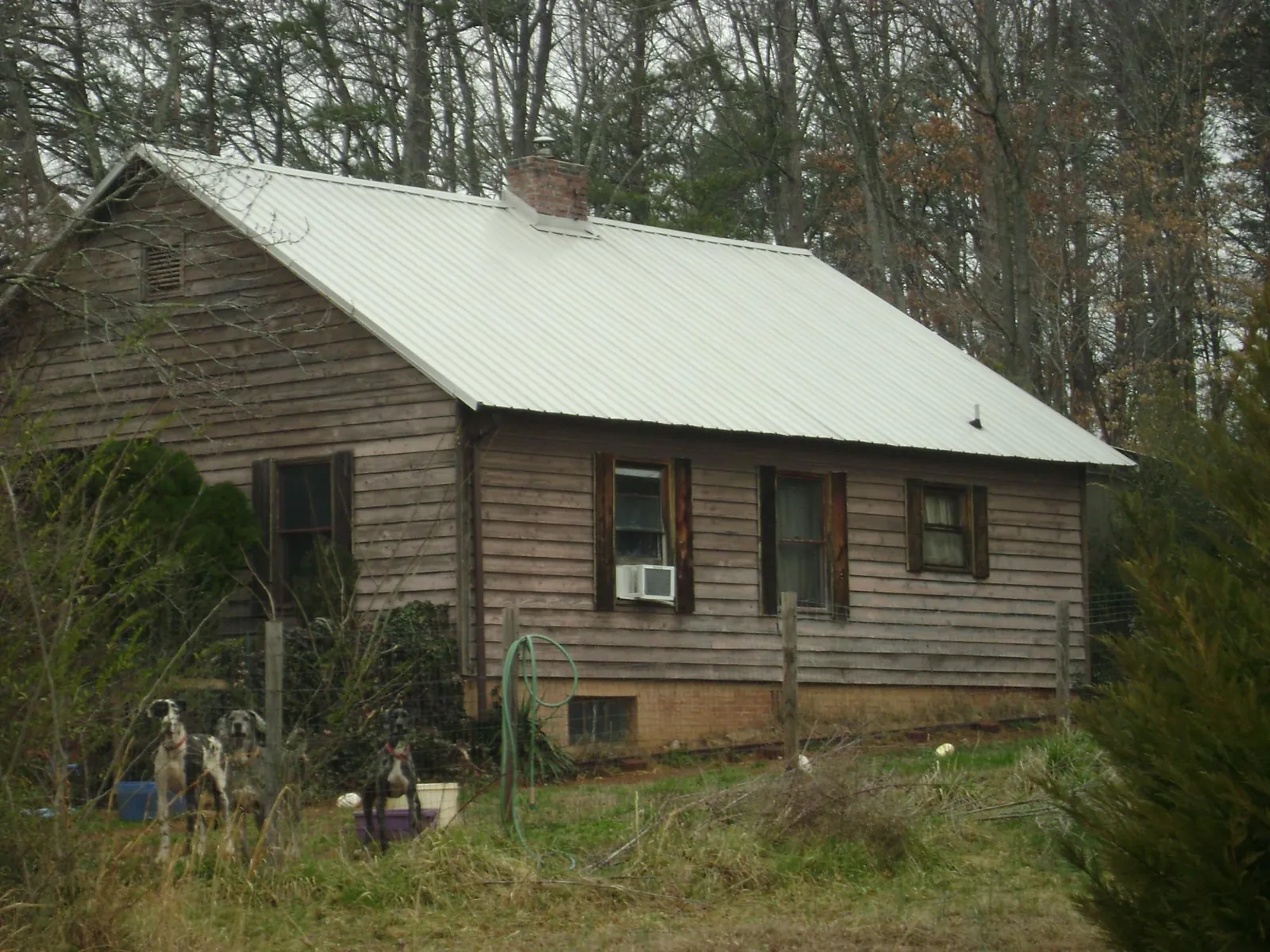 White metal roof on an old wood sided farmhouse, from a Metal Roof Installation job in Los Altos